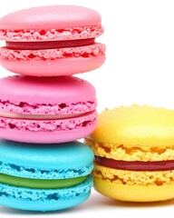 Four colorful macarons in pink, yellow, blue, and purple stacked against a white background.