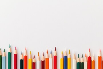 A row of colorful sharpened pencils standing upright against a plain white background.