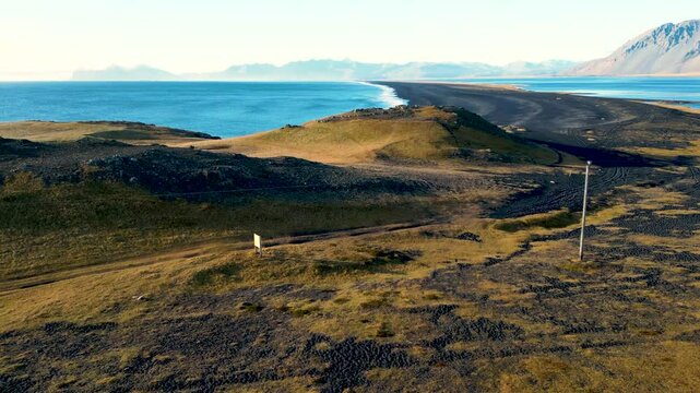  Hvalnes Nature Reserve Beach in Island zur goldenen Stunde, schwarzer Lavastrand vor dramatischer Bergkulisse unter weichem Licht an der Atlantikk&uuml;ste im Osten der Insel