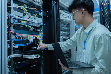 Computer engineer is setting up network in server room,Systems Maintenance Technician,Male engineer...