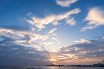 Swaying clouds and beautiful sky at sunset over the sea