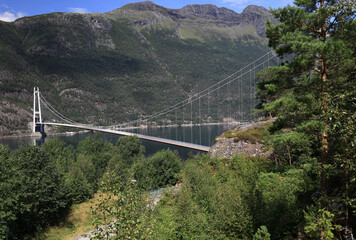 Fototapeta premium Landscape photo with a view of Hardangerbrua bridge and mountains in the background near the city of Bergen in Norway