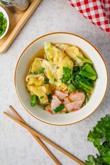 Wonton with bbq Pork Soup in a ceramic bowl