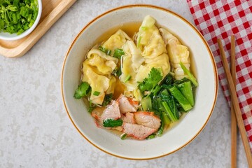 Wonton with bbq Pork Soup in a ceramic bowl