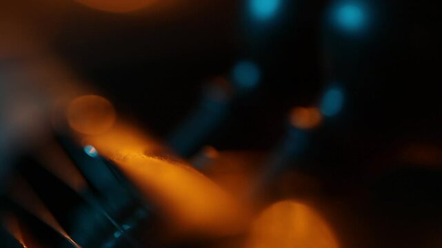 Extreme macro shot of a traditional ethnic stringed instrument. The camera slowly reveals details of the tuning pegs, strings, and fretboard with moody lighting.