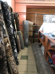 Selection of decorative rugs in a carpet shop setting