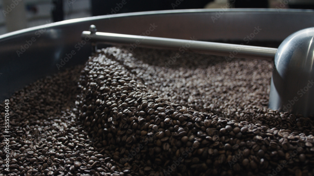 Poster coffee beans rotating in a large roasting machine