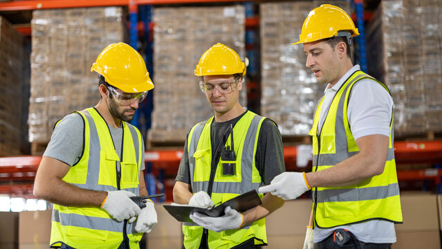 Factory workers, engineer in warehouse, International import export , logistic business concept. Logistics, transportation, distribution concept. Team of factory workers working in logistic warehouse. - Powered by Adobe