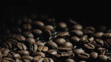 Roasted coffee beans cooling down on metal tray,