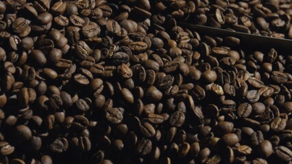 Roasted coffee beans piled high, ready for