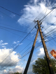 Clouds and power lines at sunset over a rural area