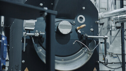 Industrial coffee roasting machine operating in