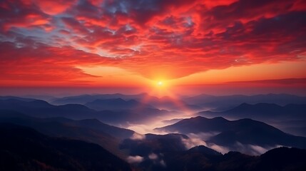 Obraz premium A high-contrast sunrise with bold orange and red hues over the Carpathian ranges, crisp mountain silhouettes in dark navy, and a glowing sun just above the horizon, painting the sky with warm tones.