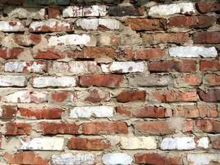 Brick wall with a mix of red and white bricks in natural light