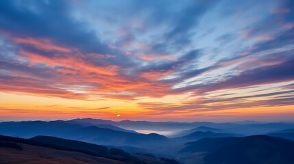 Obraz premium A vibrant sunrise sky over the Carpathian mountains, clouds swirling in shades of peach, gold, and deep blue, mountain silhouettes sharp against the brightening sky.