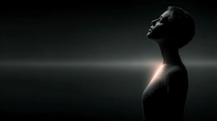 A silhouette of a woman in profile, illuminated softly from behind, highlighting her contemplative expression against a dark background.