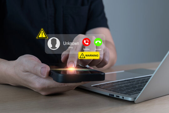 fraud or phishing with smartphone concept, person holding mobile phone receiving incoming call from scammer wtih warning sign, call center gang, hacker, cybersecurity, telecommunication concept