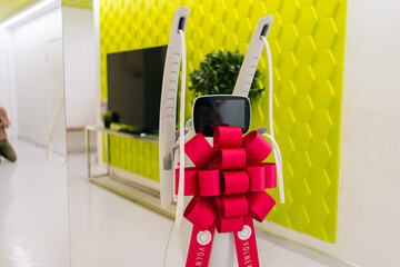 Mesotherapy apparatus with festive bow in corridor of new beauty clinic or medical center,...