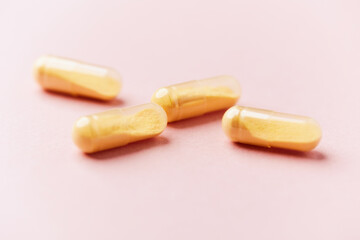 Coenzyme Q10 capsules. Antioxidants. Concept for a healthy dietary supplementation. Bright paper background. Soft focus. Close up. Copy space.	