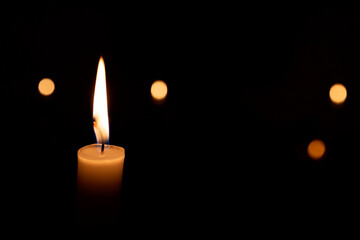 A candle is lit in a dark room