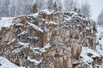 A rocky mountain covered in snow