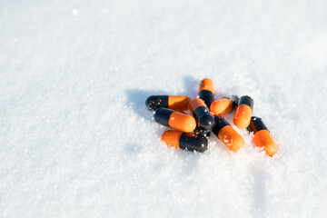 A pile of pills are scattered on the snow
