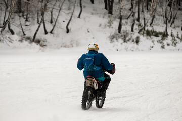 A man is riding a motorcycle in the snow