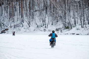 A man is riding a motorcycle in the snow