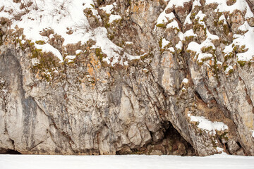 A rocky cliff covered in snow