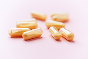 Coenzyme Q10 capsules. Antioxidants. Concept for a healthy dietary supplementation. Bright paper background. Soft focus. Close up. Copy space.	