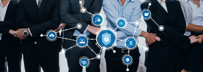 A diverse team of business professionals stands united, illustrating the concept of security with digital elements and protective icons focused on cybersecurity themes. Amity