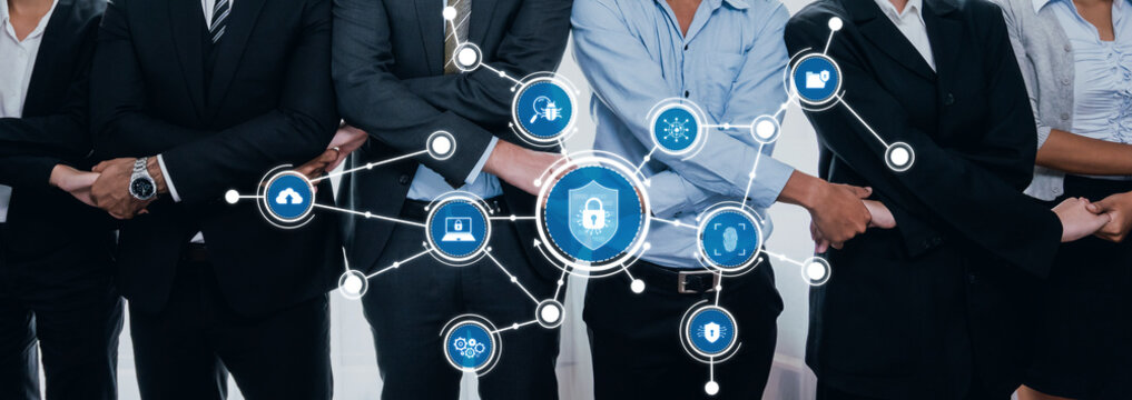 A diverse team of business professionals stands united, illustrating the concept of security with digital elements and protective icons focused on cybersecurity themes. Amity