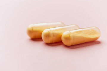 Coenzyme Q10 capsules. Antioxidants. Concept for a healthy dietary supplementation. Bright paper background. Soft focus. Close up. Copy space.	