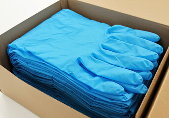 A Stack of Light Blue Nitrile Gloves in a Cardboard Box Medical Supply, Hygiene Protection, and Safety