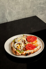 Beef sandwich with onion, lettuce, corn, tomato and cheese