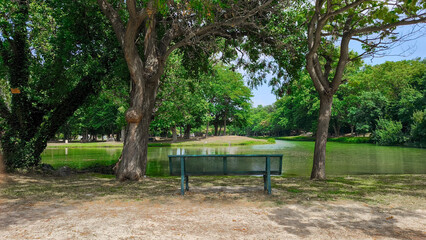 A cozy bench overlooking a serene lake in the French town of Le Soleil, rest and relaxation