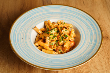 Creamy penne pasta with sausage and herbs