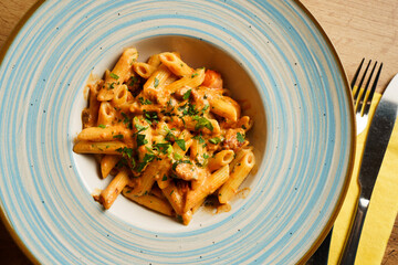 Creamy penne pasta with sausage and herbs