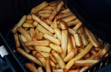 A pile of french fries in a deep fryer