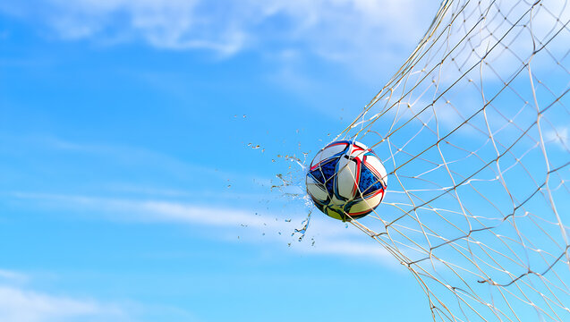 Soccer ball entering goal net with water splashes - Powered by Adobe
