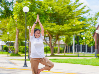 Happy asian senior woman active stretching use smart watch fitness tracker for health care in park. Elderly care female enjoying warm up exercise motivation wellness. Healthy lifestyle people smile 