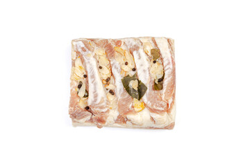 Lard or salo with bay leaf and black peas isolated on white background.