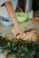 Young caucasian woman making bread dough with rolling pin and flour