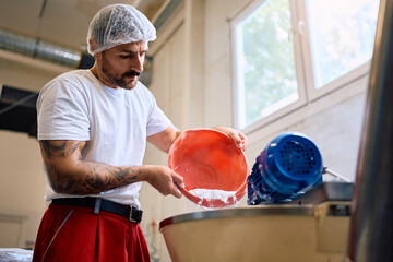 Male worker working in a food processing factory.