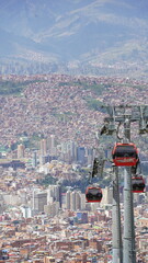 Aerial views of La Paz, Bolivia featuring the cable car system, city sprawl, and majestic snow-capped Andes mountains in the background.