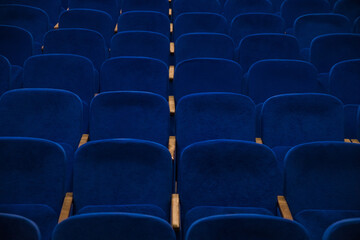 Blue empty seats in the audience prepared for the participants of the conference or presentation