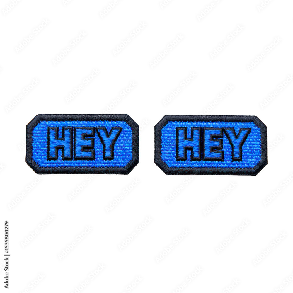 Poster two blue embroidered patches with word hey in bold black letters are displayed side by side. patches