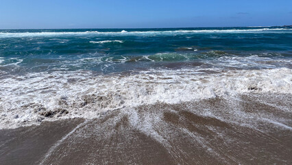 The swell returns to the sea once it reaches the beach.