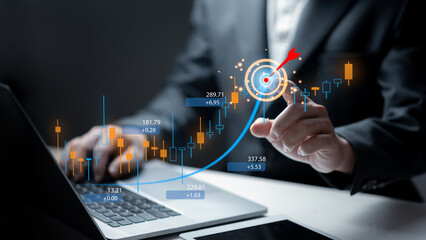 Businessman analyzing investment growth graphs data and business target concept for strategic planning and economic success on laptop with stock market charts or economy growing graph concept.