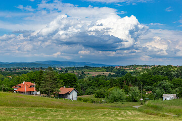 Rural area in western Serbia. Fields and hills and mountains on the horizon.
